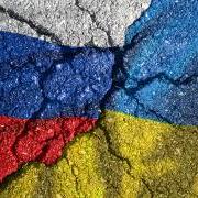 Ukraine's flag painted on a cracked surface