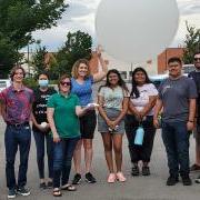 2022 cohort of the REU students in front of a weather balloon