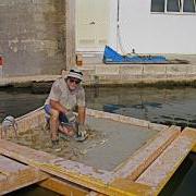 Researcher on top of concrete block submerged in the ocean.