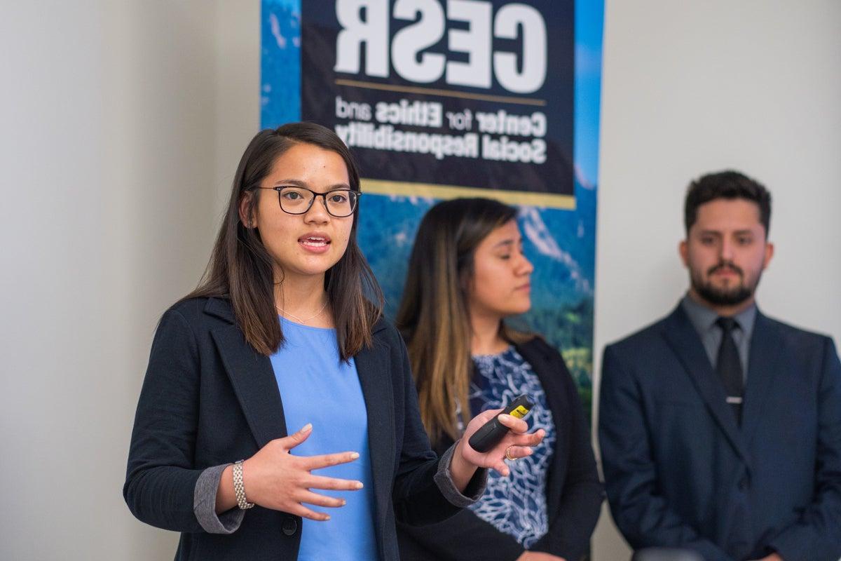 Woman speaking at a Center’s of Excellence case competition even