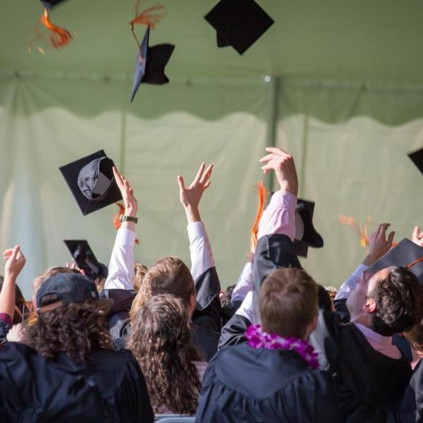 graduates throw their caps in the air