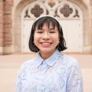 A portrait of Bianca in front of the library.