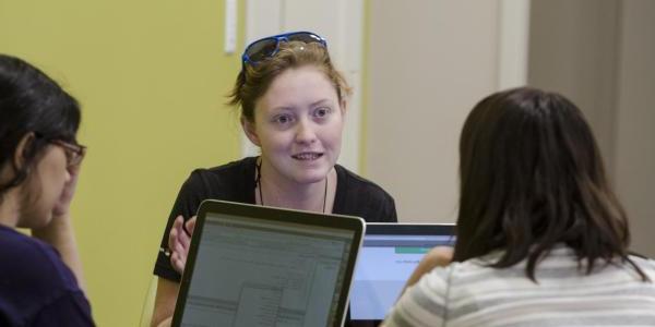 Students meeting with a tutor.