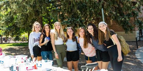 学生 posing with tie-dye supplies during a transfer student event