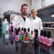 CU Boulder Professor Lupita Montoya and undergraduate student standing behind bottles of nail polish