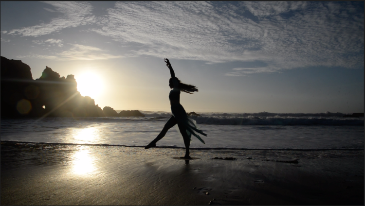 Rae Lewark performing on beach