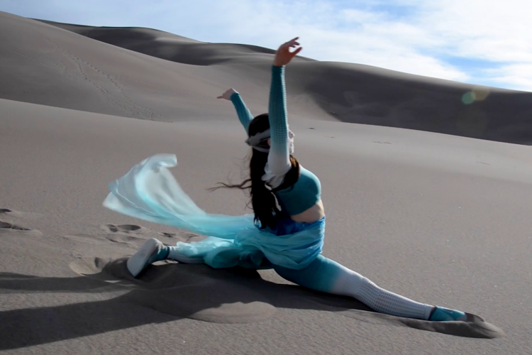 Rae Lewark performing in desert