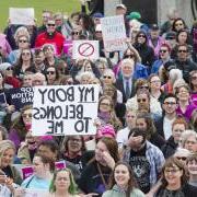 group of people marching to protest abortion ban