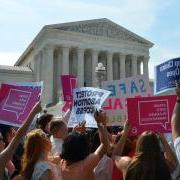 people gathering with signs during a pro-choice rally