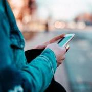 Person checking their phone while walking