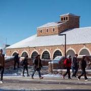 students walk across a snowy campus