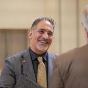 CU Boulder Chancellor Justin Schwartz interacts with a person standing before him. 