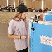 Student voting in person in the UMC Vote Center